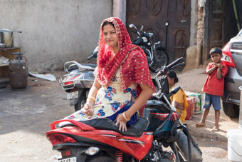 Indian woman sitting on motorcycle Hyderabad India