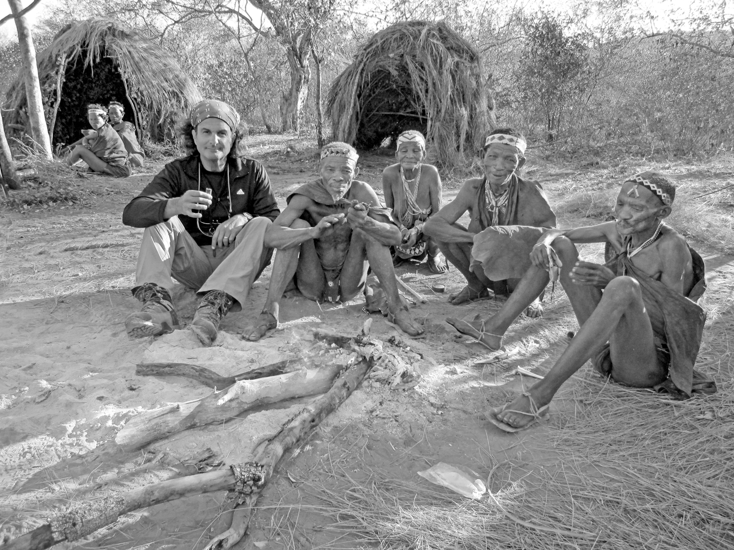 Chris Marino sitting with bush folk in the kalahari
