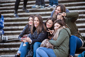 girls taking selfies on piazza steps Rome Italy